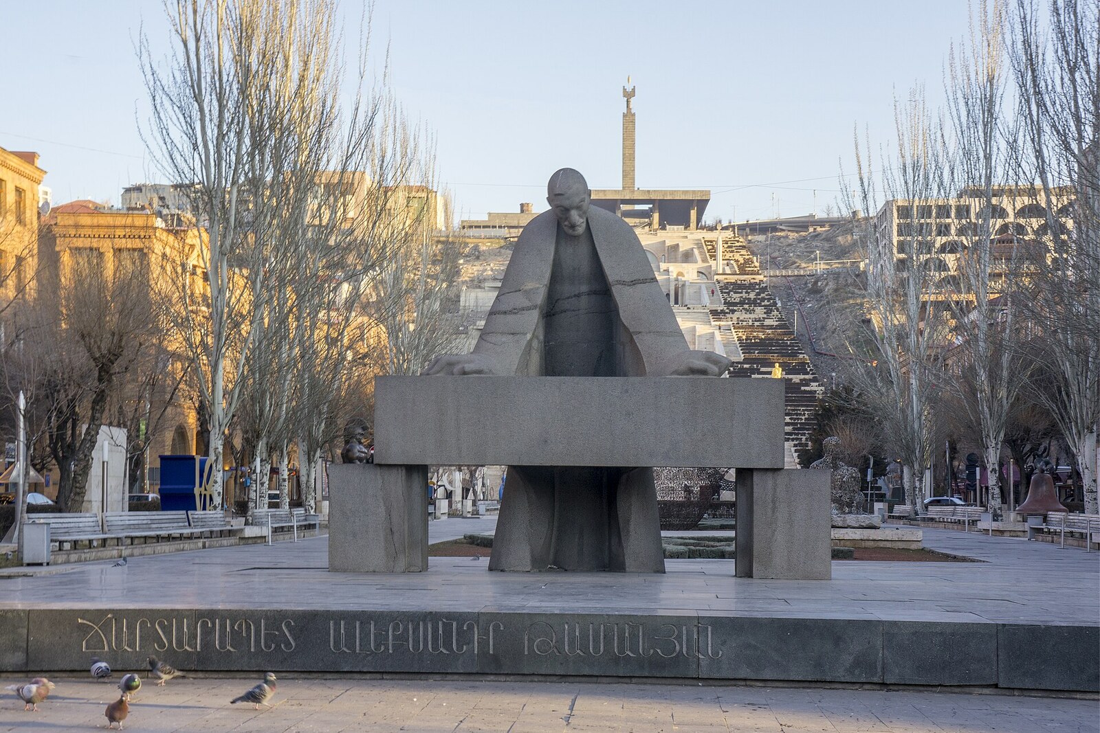 Stone figure of Tamanian between two blocks at the beginning of the park