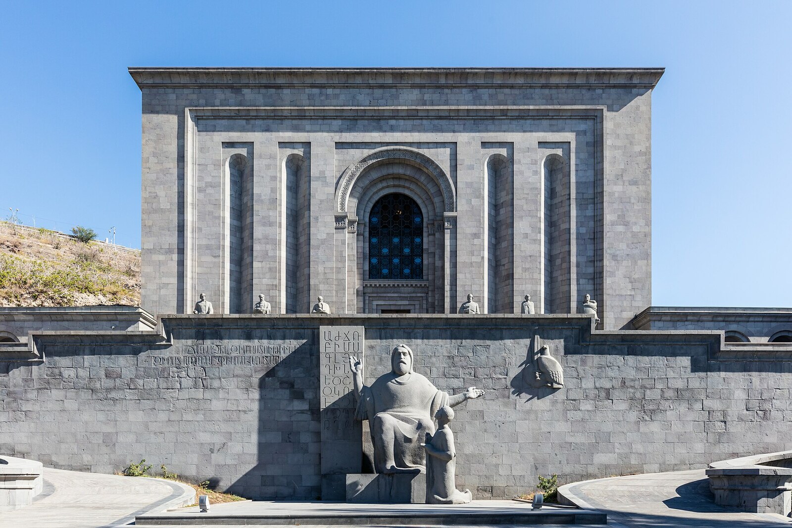 The monumental stone facade of the Matenadaran at the top of the staircase
