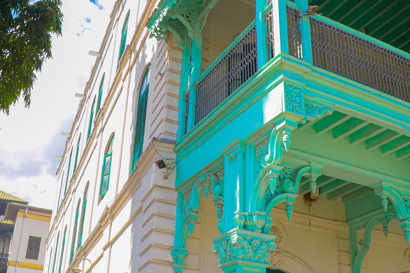 The historic Old Dispensary building with carved balconies painted green