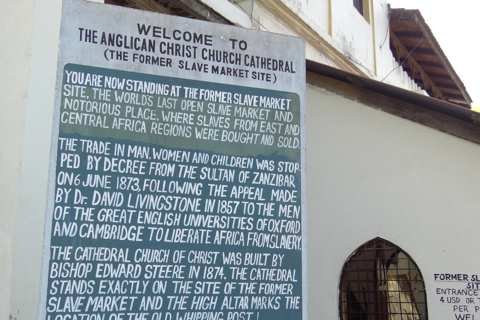 Sign by the Anglican cathedral and former slave market in Stone Town