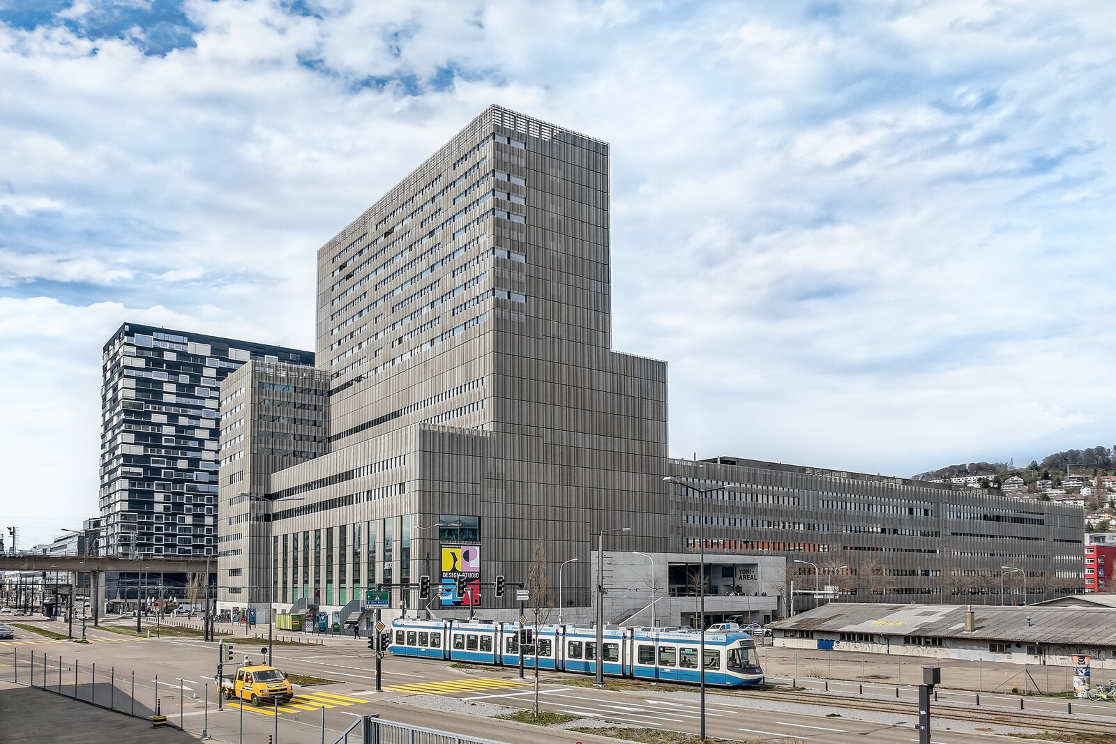 View of the Toni-Areal building with a glass tower and a low-rise section